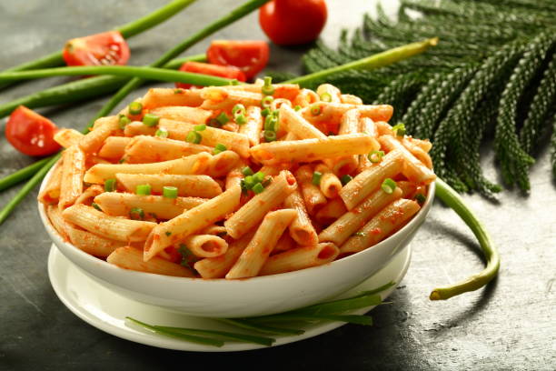 Italian cuisine- homemade penne pasta cooked with tomatoes and fresh vegetables.