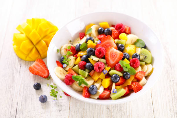 fresh juicy fruits salad in bowl