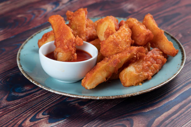 Potatos wedges with tomato sauce served in dish isolated on background side view of fastfood