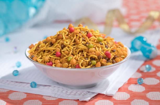 Delicious and crunchy Mix Nimco in simple white bowl, namkeen made from gram flour, dal, peanuts, and mix of indian traditional spices